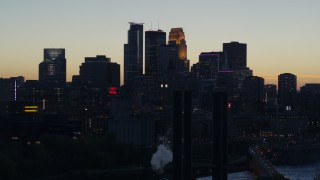 DX0001_002566 - 5.7K aerial stock footage of the city skyline across the river at twilight, seen from power plant, Downtown Minneapolis, Minnesota
