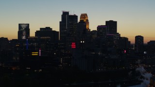 DX0001_002576 - 5.7K aerial stock footage flyby skyscrapers lit for night in the city skyline at twilight, Downtown Minneapolis, Minnesota