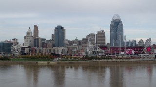 DX0001_002587 - 5.7K aerial stock footage ascend from Ohio River and focus on city skyline and baseball stadium, Downtown Cincinnati, Ohio