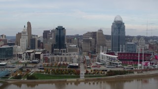 DX0001_002588 - 5.7K stock footage aerial video flying by city skyline and baseball stadium, seen from the river, Downtown Cincinnati, Ohio