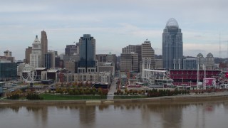 DX0001_002589 - 5.7K stock footage aerial video flying by city skyline and baseball stadium, seen from the river during descent, Downtown Cincinnati, Ohio
