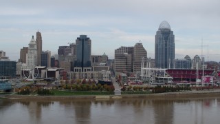 DX0001_002590 - 5.7K aerial stock footage passing by city skyline and baseball stadium, seen from the river, Downtown Cincinnati, Ohio