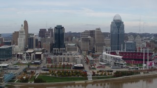 DX0001_002592 - 5.7K aerial stock footage focus on city skyline and baseball stadium during ascent from river, Downtown Cincinnati, Ohio