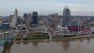 DX0001_002593 - 5.7K aerial stock footage fly away from city skyline and baseball stadium beside Ohio River, Downtown Cincinnati, Ohio