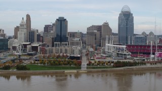 DX0001_002595 - 5.7K aerial stock footage of flying by city skyline and baseball stadium by Ohio River, Downtown Cincinnati, Ohio