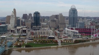 DX0001_002596 - 5.7K aerial stock footage ascend and fly away from city skyline and baseball stadium by Ohio River, Downtown Cincinnati, Ohio