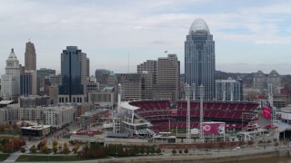 DX0001_002613 - 5.7K aerial stock footage reverse view of skyscraper and baseball stadium from river, Downtown Cincinnati, Ohio