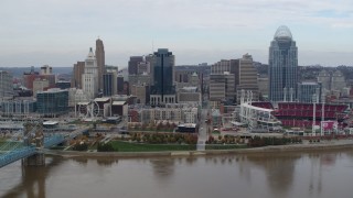 DX0001_002620 - 5.7K aerial stock footage flyby a riverfront baseball stadium and skyline while ascending over river, Downtown Cincinnati, Ohio