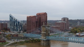DX0001_002625 - 5.7K aerial stock footage of flying by two riverfront office buildings and bridge in Covington, Kentucky