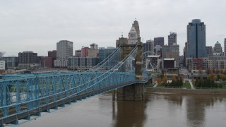 DX0001_002634 - 5.7K stock footage aerial video fly over Ohio River beside the bridge toward the city skyline, Downtown Cincinnati, Ohio