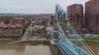 DX0001_002654 - 5.7K aerial stock footage descend by Roebling Bridge toward the Ohio River in Covington, Kentucky
