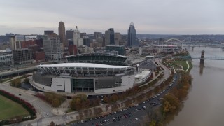 DX0001_002682 - 5.7K aerial stock footage reverse view of football stadium and skyline, reveal Ohio River in Downtown Cincinnati, Ohio