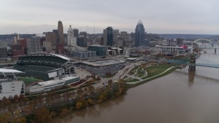 DX0001_002683 - 5.7K stock footage aerial video flyby football stadium and skyline, seen from Ohio River in Downtown Cincinnati, Ohio