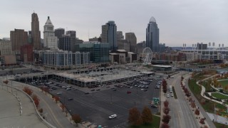 DX0001_002692 - 5.7K aerial stock footage descent near parking lot with view of the city's skyline in Downtown Cincinnati, Ohio