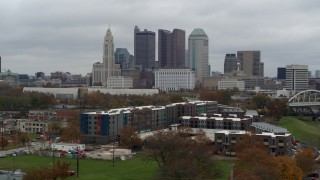 DX0001_002695 - 5.7K aerial stock footage descent near apartment complex with view of skyline in Downtown Columbus, Ohio