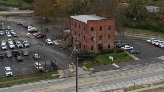 DX0001_002709 - 5.7K aerial stock footage of orbiting a small brick police station in Columbus, Ohio