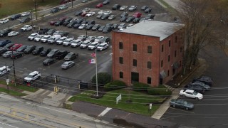 DX0001_002711 - 5.7K aerial stock footage of approaching a small brick police station in Columbus, Ohio
