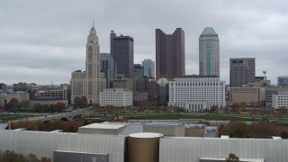 DX0001_002717 - 5.7K aerial stock footage ascend near science museum for view of city's skyline, Downtown Columbus, Ohio