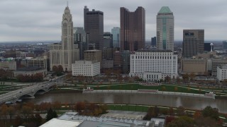 DX0001_002723 - 5.7K aerial stock footage of a reverse view of the Scioto River and the city skyline, Downtown Columbus, Ohio
