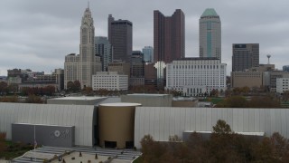 DX0001_002725 - 5.7K aerial stock footage ascend over science museum to reveal river and approach city skyline, Downtown Columbus, Ohio