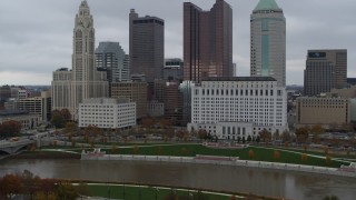 DX0001_002726 - 5.7K aerial stock footage reverse view of river and city skyline, reveal the science museum, Downtown Columbus, Ohio