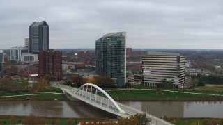 DX0001_002735 - 5.7K aerial stock footage ascend by riverfront condo complex and office building by bridge and river, Downtown Columbus, Ohio