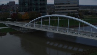 DX0001_002737 - 5.7K aerial stock footage of the Main Street Bridge spanning the Scioto River at sunset, Downtown Columbus, Ohio