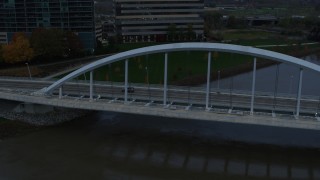 DX0001_002738 - 5.7K aerial stock footage reverse view of the Main Street Bridge spanning the Scioto River at sunset, Downtown Columbus, Ohio