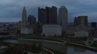 DX0001_002750 - 5.7K aerial stock footage stationary view of the city skyline and the Scioto River at sunset, Downtown Columbus, Ohio