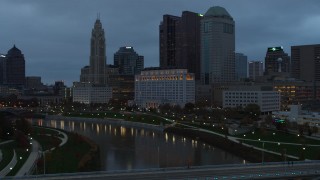 DX0001_002753 - 5.7K aerial stock footage of the city skyline and the Scioto River at sunset during ascent, Downtown Columbus, Ohio