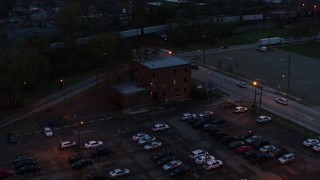 DX0001_002763 - 5.7K aerial stock footage of a reverse view of a brick police station at twilight in Columbus, Ohio