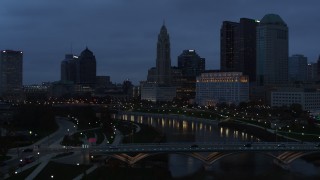 DX0001_002771 - 5.7K aerial stock footage flying over bridges to approach the city skyline at twilight, Downtown Columbus, Ohio