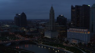 DX0001_002772 - 5.7K aerial stock footage of LeVeque Tower across the river at twilight, Downtown Columbus, Ohio