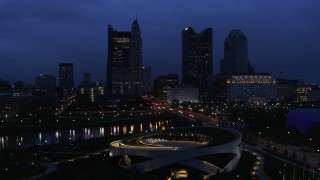 DX0001_002774 - 5.7K aerial stock footage of flying by the city skyline across the river at twilight, Downtown Columbus, Ohio