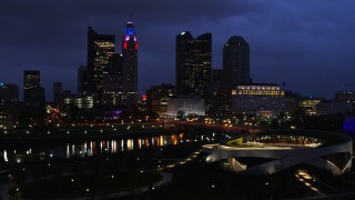 DX0001_002784 - 5.7K aerial stock footage of the city's skyline across the river at twilight during ascent in Downtown Columbus, Ohio