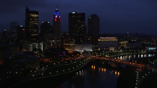 DX0001_002788 - 5.7K aerial stock footage of  the city's skyline beside a bridge and river at twilight, Downtown Columbus, Ohio