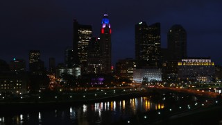 DX0001_002793 - 5.7K aerial stock footage ascend to reveal the river and approach city skyline at night, Downtown Columbus, Ohio