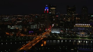 DX0001_002800 - 5.7K aerial stock footage of LeVeque Tower and bridge spanning the river at night, Downtown Columbus, Ohio