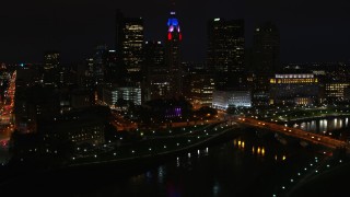DX0001_002802 - 5.7K aerial stock footage of passing by LeVeque Tower and bridge spanning the river at night, Downtown Columbus, Ohio