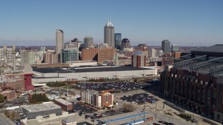 DX0001_002807 - 5.7K aerial stock footage reverse view of skyline behind convention center, reveal brick factory, Downtown Indianapolis, Indiana