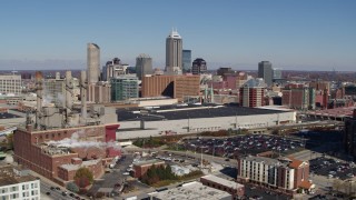 DX0001_002810 - 5.7K aerial stock footage reverse view of brick factory, convention center and city skyline, Downtown Indianapolis, Indiana