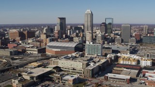 DX0001_002840 - 5.7K aerial stock footage of flying away from arena and the city's skyline in Downtown Indianapolis, Indiana
