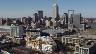 DX0001_002843 - 5.7K aerial stock footage descend while focusing on the city's skyline in Downtown Indianapolis, Indiana