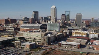 DX0001_002845 - 5.7K aerial stock footage fly away from arena and by the city's skyline in Downtown Indianapolis, Indiana