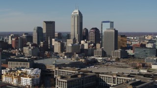 DX0001_002857 - 5.7K aerial stock footage of a reverse view of tall skyscrapers in the city's skyline in Downtown Indianapolis, Indiana