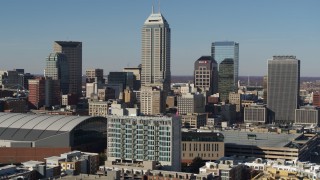 DX0001_002860 - 5.7K aerial stock footage of slowly flying by tall skyscrapers in the city's skyline, reveal arena in Downtown Indianapolis, Indiana