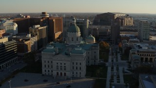 DX0001_002910 - 5.7K stock footage aerial video reverse view of the Indiana State House and ascend in Downtown Indianapolis, Indiana