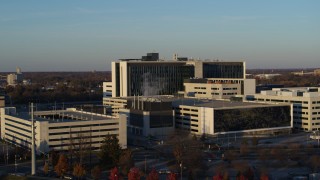 DX0001_002915 - 5.7K aerial stock footage of flying by a hospital complex at sunset in Indianapolis, Indiana