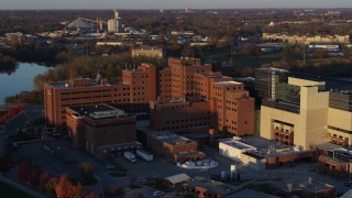 DX0001_002918 - 5.7K aerial stock footage flying by and away from a VA hospital complex at sunset in Indianapolis, Indiana