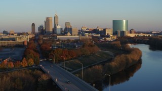 DX0001_002921 - 5.7K aerial stock footage of the city's skyline seen from the White River at sunset, Downtown Indianapolis, Indiana